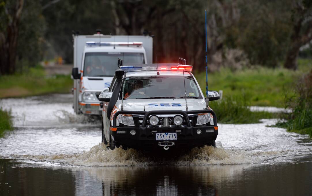 Emergency services help a car out of floodwater near Wangaratta earlier this month.