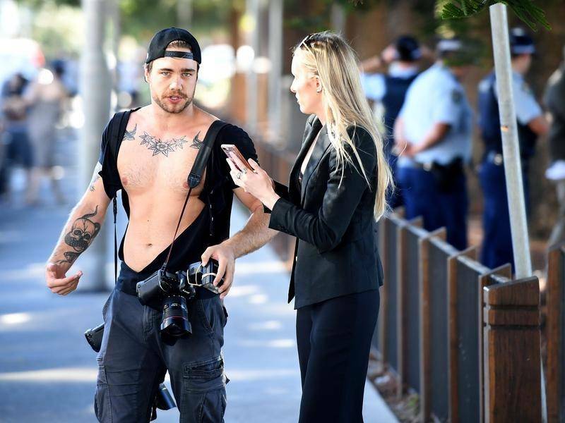 News Corp photographer Dylan Robinson had his shirt ripped open following a confrontation.