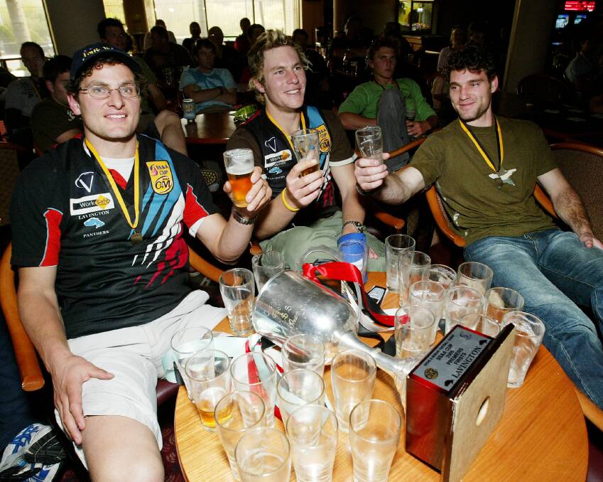CHEERS: Clint Dickins, Brandon Mathews and Adam Butler celebrate the Panthers' thrilling grand final win over Myrtleford in 2005.
