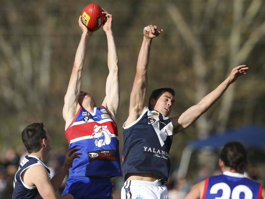 WAY TO GO: Thurgoona ruckman Adam Way stretches for a mark opposed to Paul Giltrap.