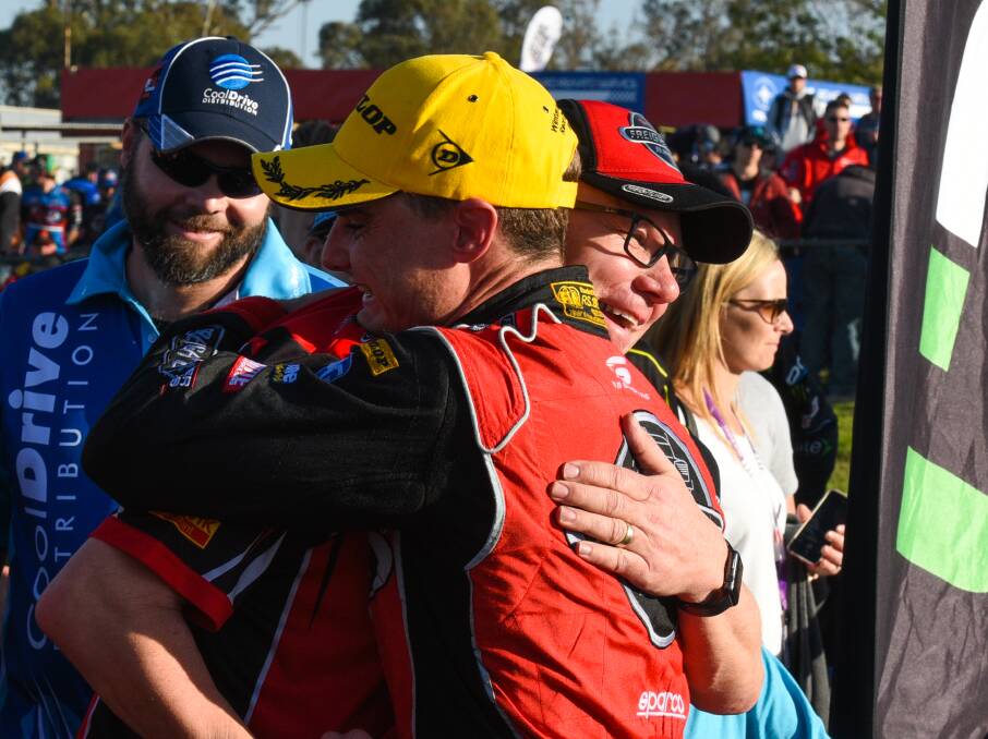 GIVE US A HUG: Tim Slade and Brad Jones share a moment after Sunday's victory at Winton.