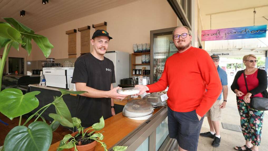 MADE TO-GO: Corowa business Doc Yarrum owner Jack Schilg serves customer Phillip Nielsen at the new takeaway window. A modified takeaway menu and home delivery service is now offered. Picture: JAMES WILTSHIRE
