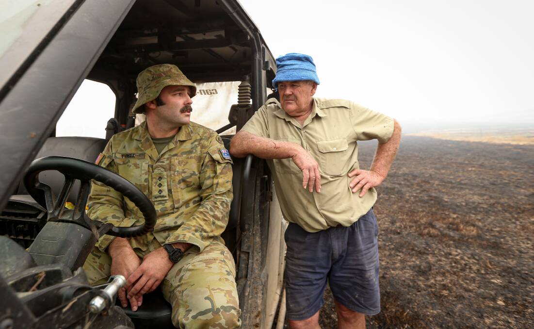 A HELPING HAND: Captain Nick Tyrell and his father Graeme at the family's scorched Upper Murray farm near Biggara last week. Pictures: JAMES WILTSHIRE
