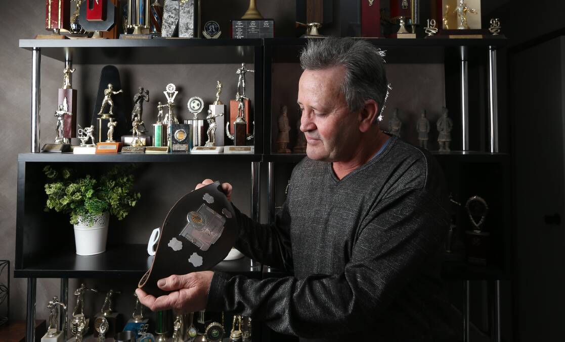 Graeme Melbourne with some of his sons' boxing trophies. Picture: KYLIE ESLER