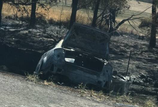 The crashed Audi by the side of the freeway.