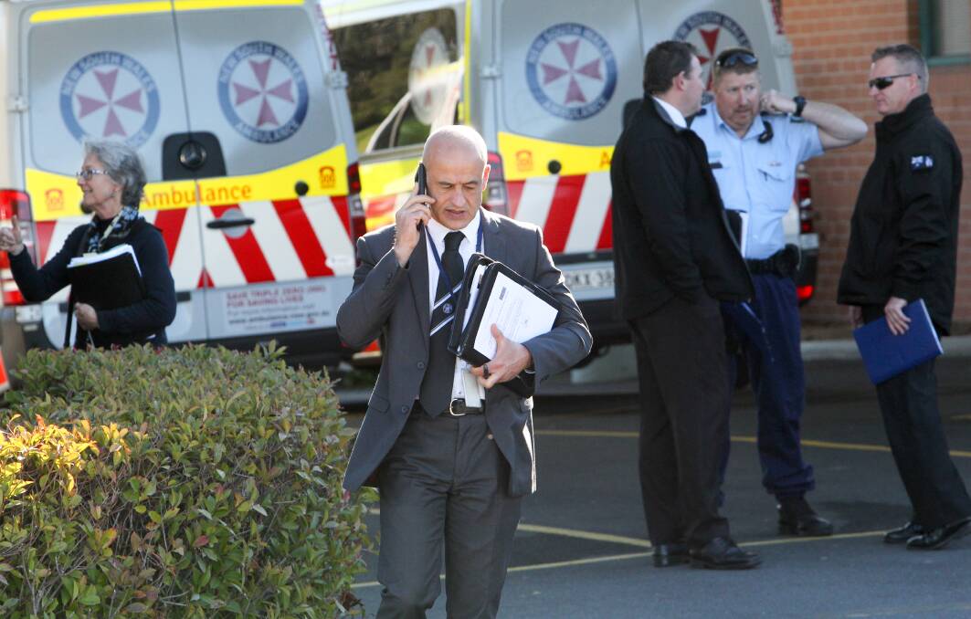Detectives from Victoria Police's Armed Crime Squad, as well as Wodonga and Albury, at Albury Hospital on Monday afternoon after Albury magistrate Rodney Brender granted Joshua Clavell's extradition to Victoria. Clavell was represented by Sue Robey (left), who appeared via a telephone link to the hospital.