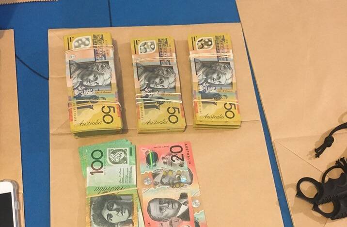 Some of the $50,000 in cash seized by police, who claim the money was the proceeds of a major illicit drug operation.