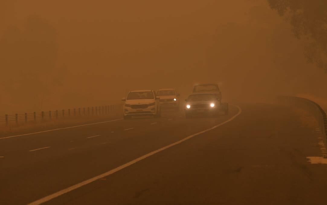 Motorists make their way through heavy smoke on the Hume Freeway near Wodonga on Sunday. The smoke persisted throughout the day. Picture: TARA TREWHELLA
