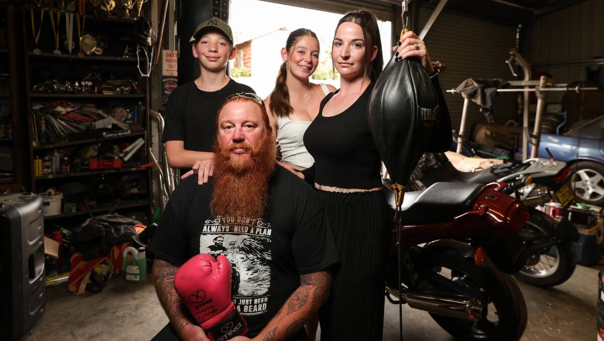 Nathan Symonds and Natalie Coall with children Keeley and Cayden in the back shed of their Corowa home where oldest child Savanna used to do boxing training with her dad. Picture by James Wiltshire