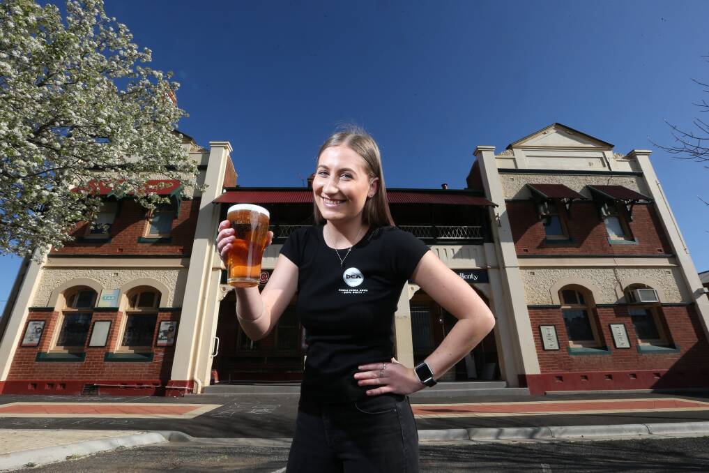 Bartender Georgie McCallum outside the pub in the lead-up to the 2018 Henty field days, one of the busiest times of the year for the Doodle Cooma Arms crew.