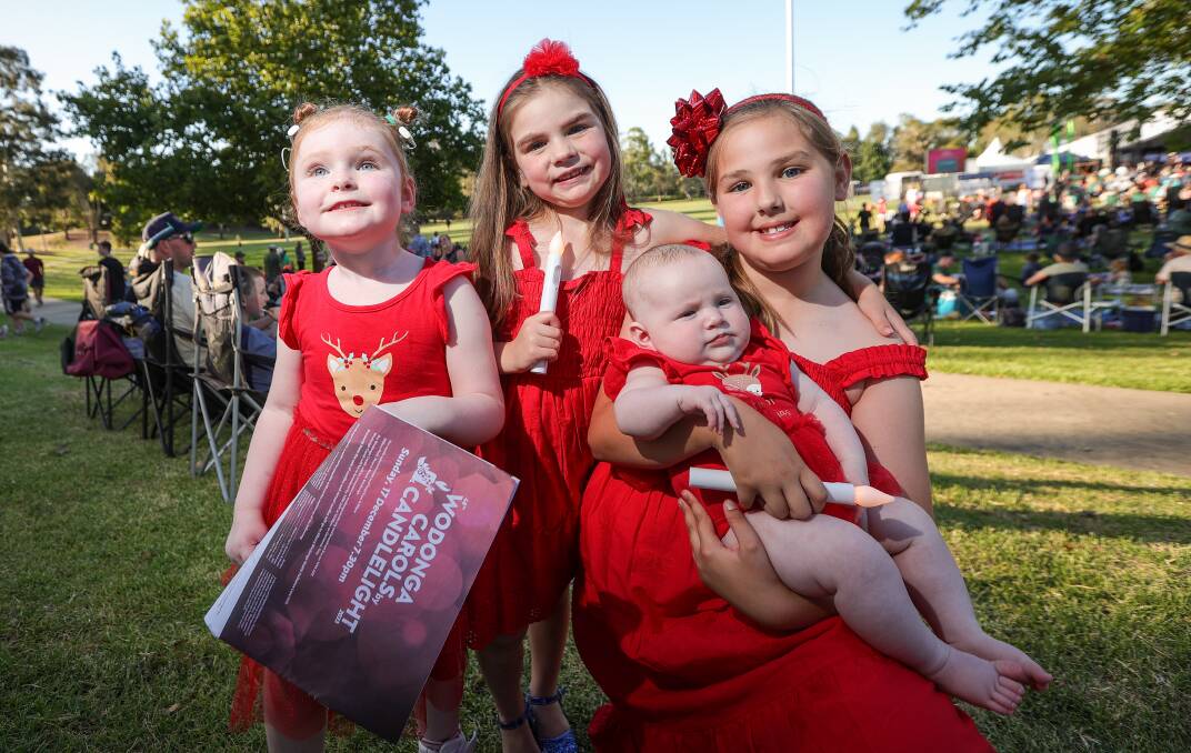 Ivy Stokes, 3, Evelyn McKenna, 5, Della McKenna, 9, and Sophie Stokes, two months, were among the Wodonga children enjoying the carols at Willow Park.