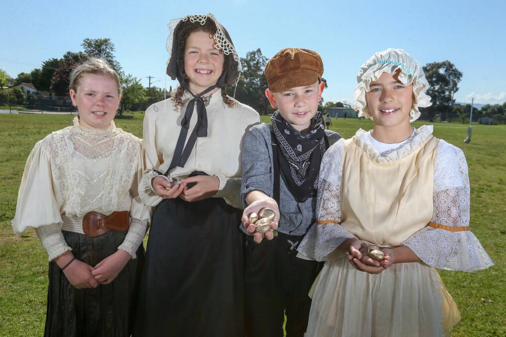 BYGONE ERA: Year 5 students Alice Bell, Annabell Doherty, Jack Oliver and Isla Horvatic, all 11, dress in period clothes and hunt for gold as part of Tuesday's schedule at St Anne's Primary School. Picture: TARA TREWHELLA