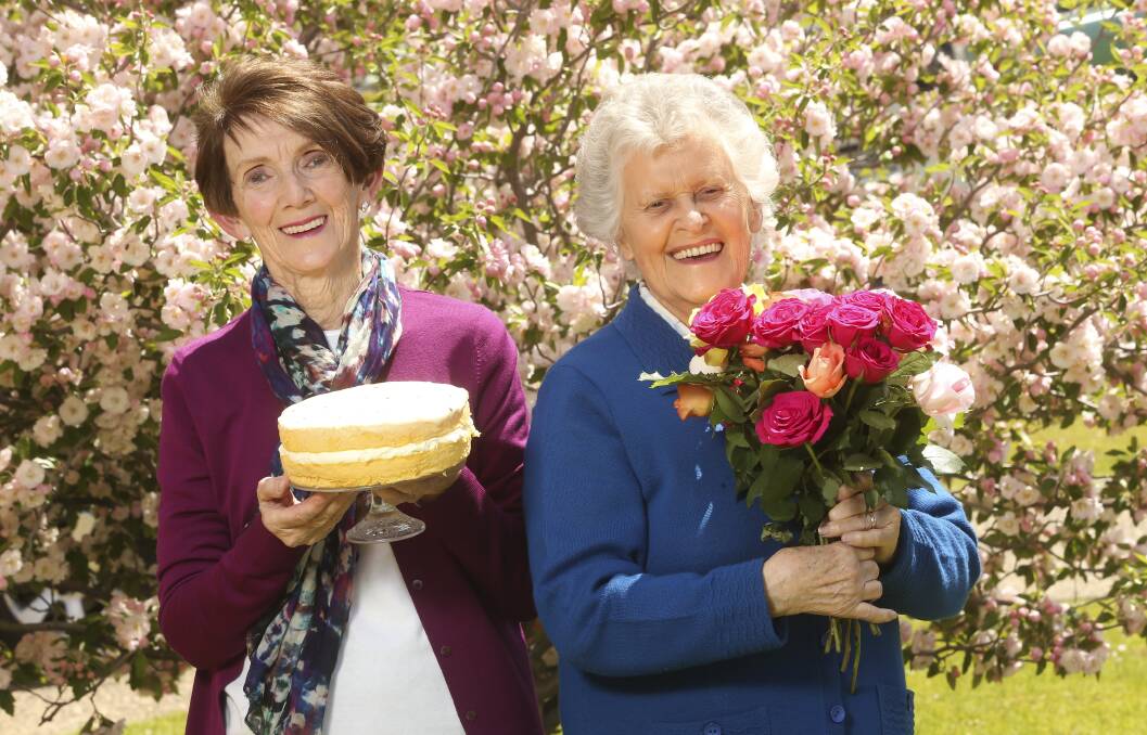 SPONGE AND ROSES: Aileen Tetu and Dawn Gould hold two of the annual Rose-A-Fair's most popular attractions. Picture: ELENOR TEDENBORG
