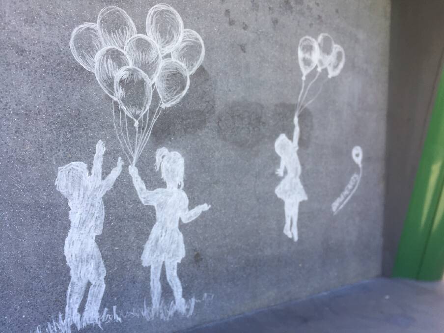 PROTECT CHILDREN: Chalk drawings by Albury artist Tracie MacVean on the wall of Retro Cafe, Albury. Picture: JANET HOWIE