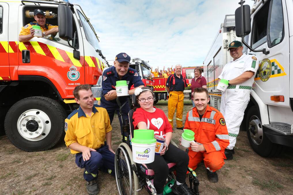 TEAM EFFORT: Albury's Lil Dyball, 10, with Good Friday Appeal volunteers including Rural Fire Service Thurgoona deputy captain Rob Baumgarten, Albury Civic Fire Station captain John Vandeven, Good Friday Appeal co-ordinator Alex Todd, Wodonga Lions Club secretary Marie Furze, State Emergency Service member Callan Spalding and Albury Volunteer Rescue Association captain Paul Marshall. Picture: KYLIE ESLER
