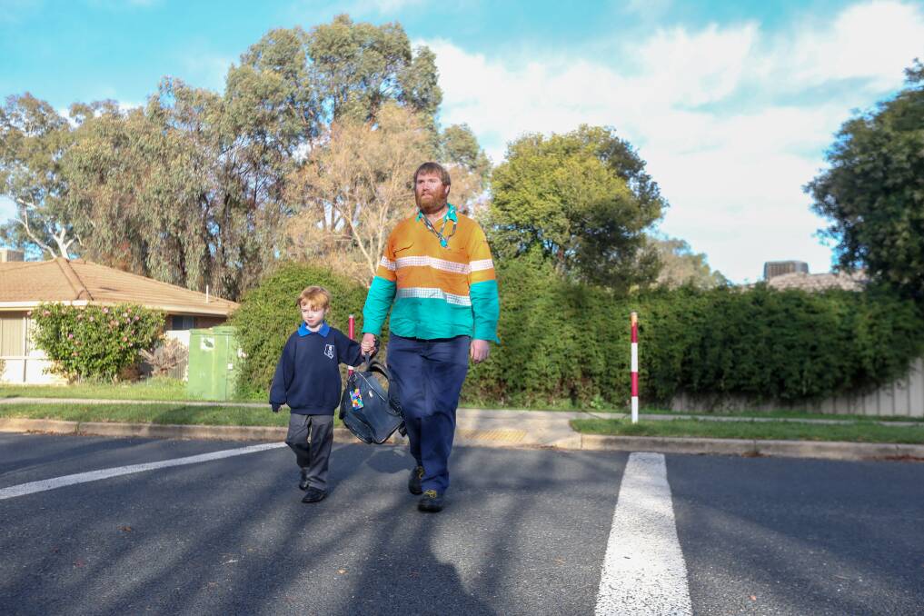 REGULAR ROUTINE: Colton Talmage, 5, and his father Wade joined many students and parents bound for Thurgoona Public School on Monday. Picture: TARA TREWHELLA