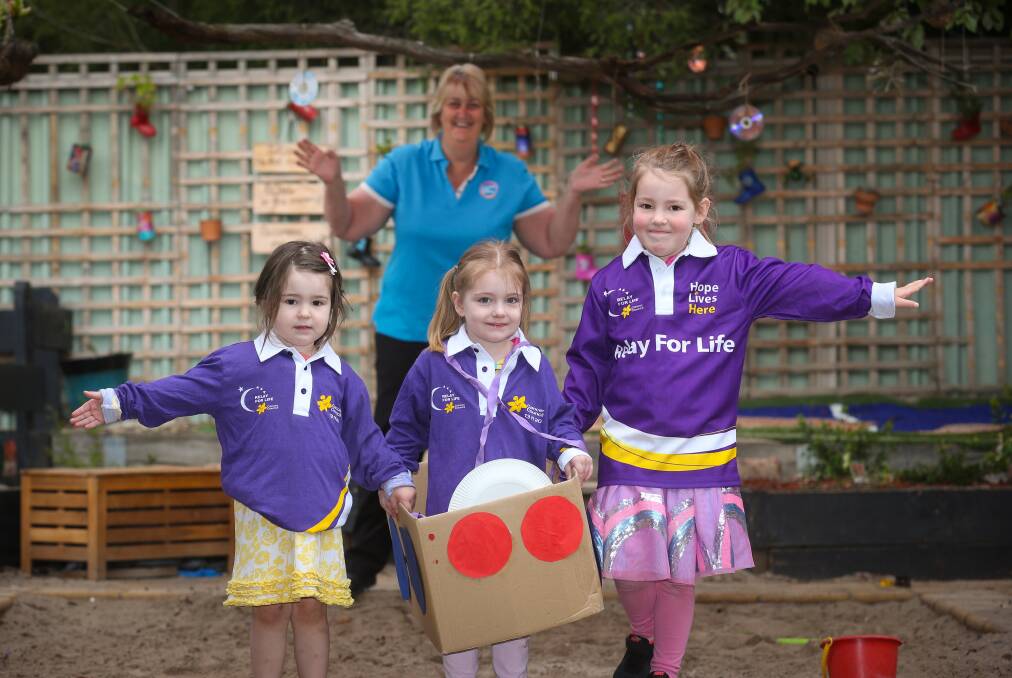 DECORATED BOX RACE: Shelbie Ritchie, 3, Victoria Holmes, 3, and Scarlett Ritchie, 4, get into the Border Relay For Life Spirit, with Goodstart educator Debbie Reid. Picture: KYLIE ESLER