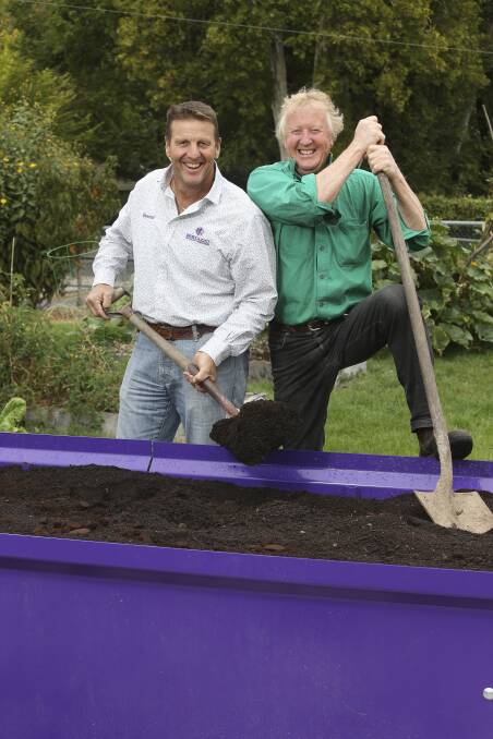WORKING TOGETHER: Raymond Bertazzo and Peter Atkins stand in the Bungam Community Garden with the new garden bed built by Mr Bertazzo. Picture: ELENOR TEDENBORG