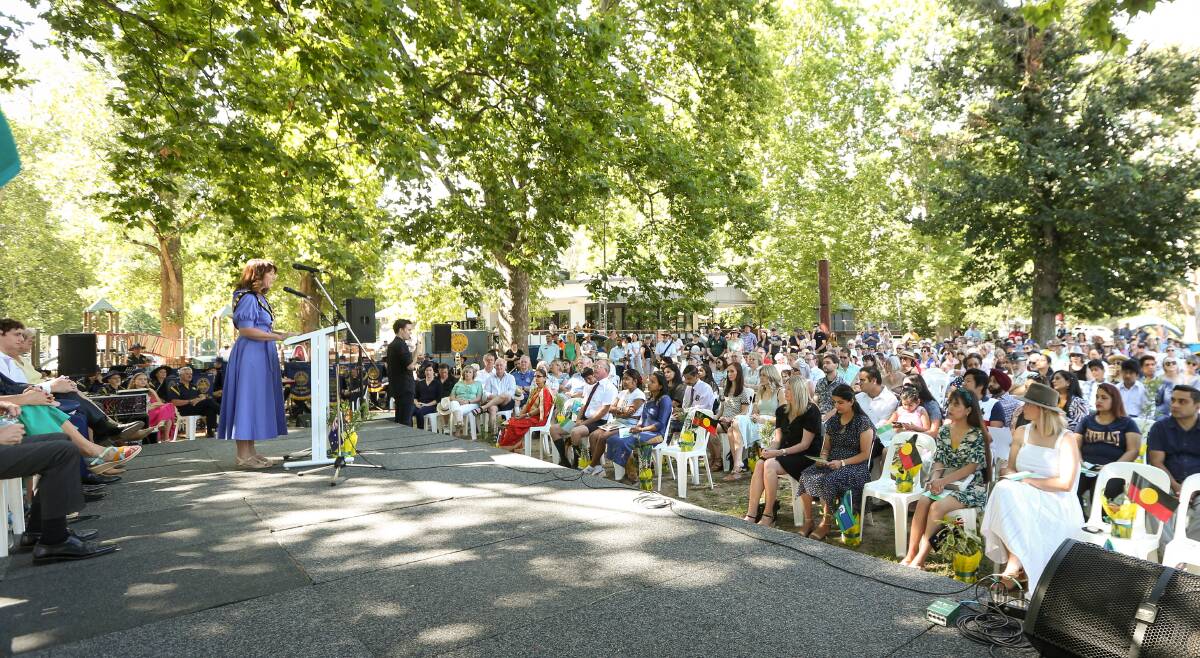 Albury mayor Kylie King stands at the microphone during the city's 2023 Australia Day ceremony in Noreuil Park on January 26. Picture by James Wiltshire