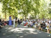 Albury mayor Kylie King stands at the microphone during the city's 2023 Australia Day ceremony in Noreuil Park on January 26. Picture by James Wiltshire
