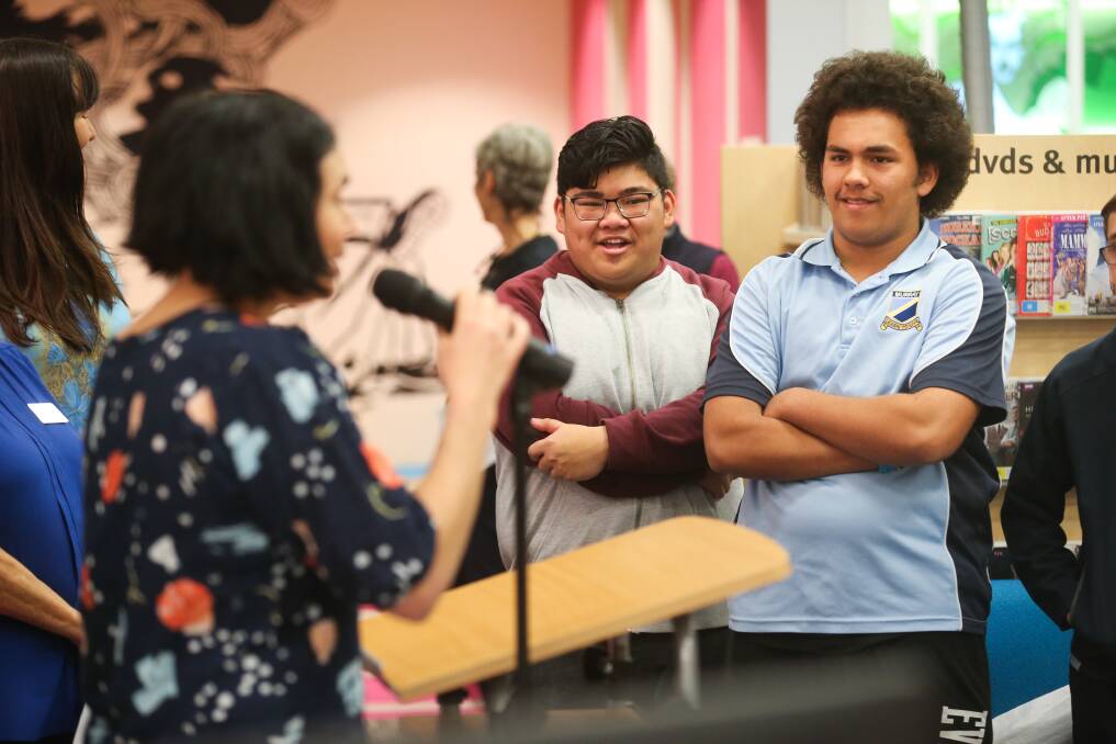 FESTIVAL OPENING: Youth Comic Art Project contributors Gino Soydara, 19, and Tremaine Newman, 15, listen to comic artist Mandy Ord as the mural is launched at Lavington Library.
