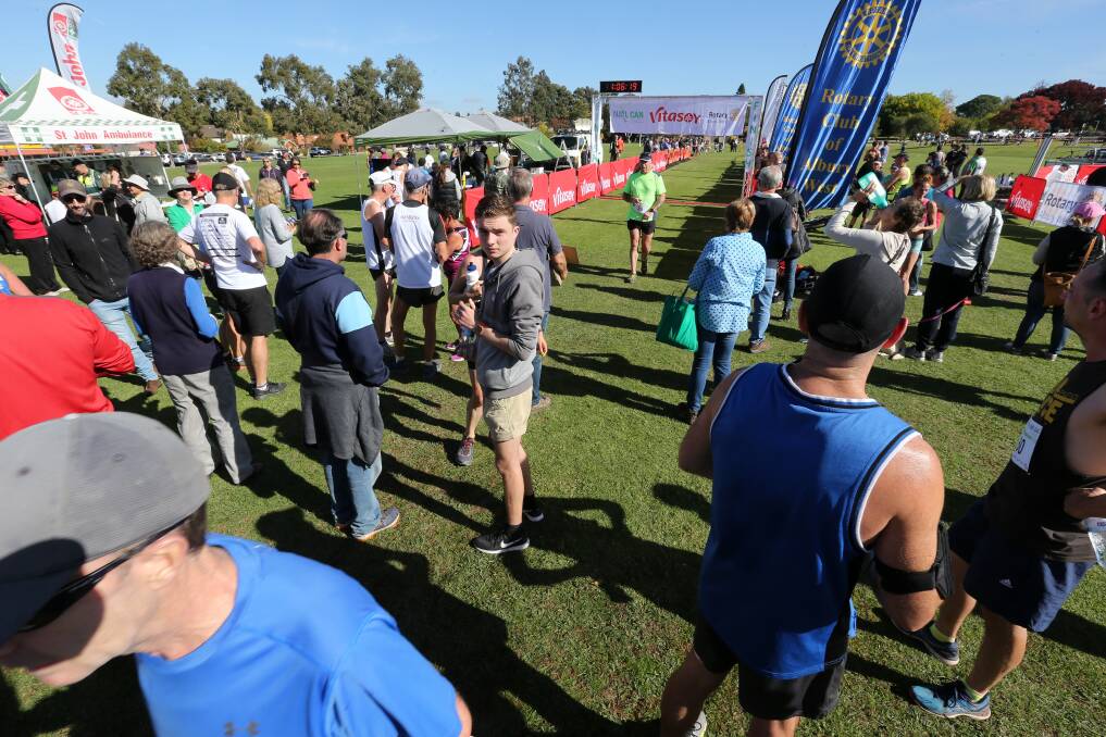 END POINT: Competitors and spectators mingle near the finish line of Sunday's Nail Can Hill Run at Bonnie Doon Park, West Albury. Organisers are thinking about changing the location of the race finish in the future. Picture: KYLIE ESLER