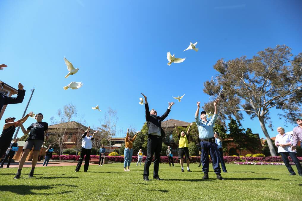 FLYING FREE: It's a socially distant release of birds in Albury's QEII Square on Friday as the council, police and services take part in White Balloon Day. Picture: JAMES WILTSHIRE