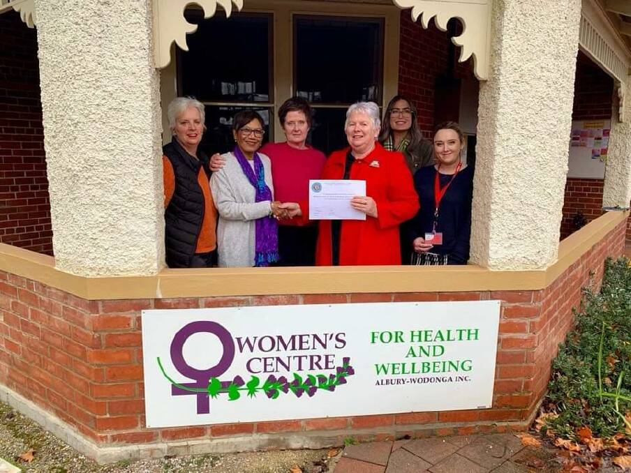 GRATEFULLY RECEIVED: Albury Evening CWA branch president Judy Haines presents a cheque to the Women's Centre for Health and Wellbeing Albury-Wodonga, as branch members look on.