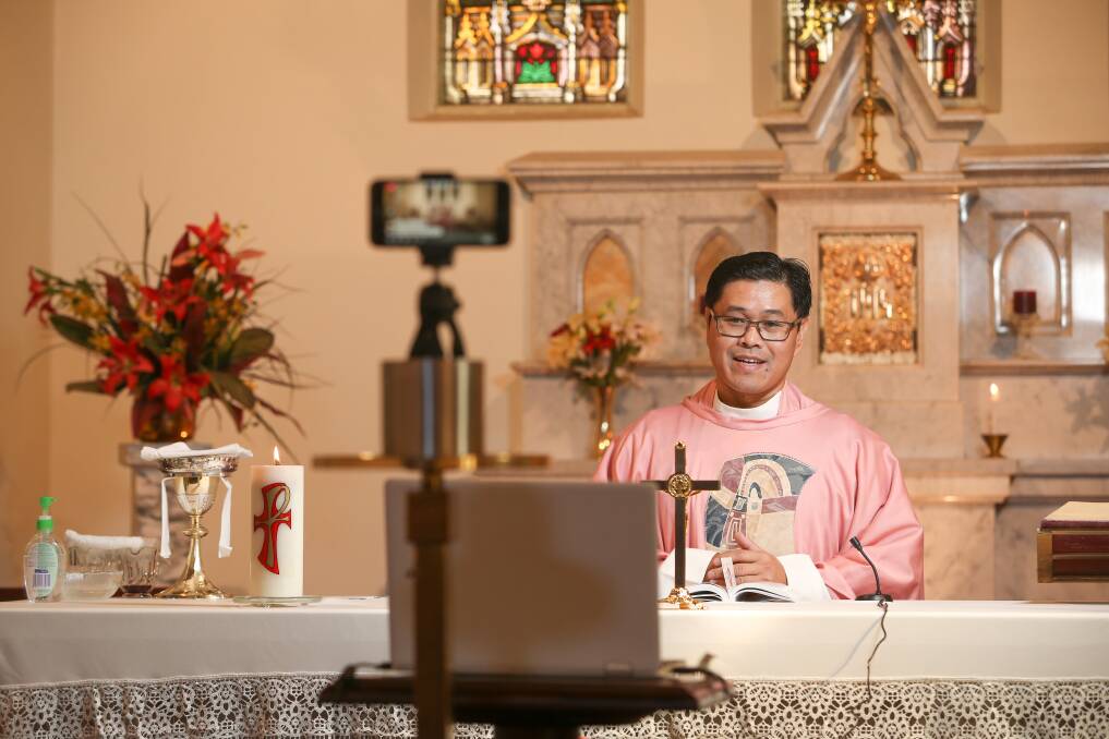 Father Junjun Amaya holds Sunday mass via Facebook Live at St Augustine's, Wodonga, in March 2020 as COVID-19 restrictions take effect. Picture by James Wiltshire