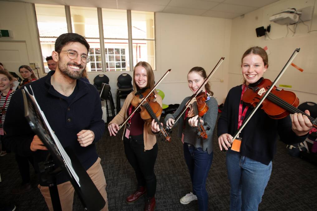 CREATIVE PROCESS: Border Music Camp composer Andrew Aronowicz works with Hayley Cartwright, 16, Erin Swann, 14, and Mia Davidson, 15. Picture: JAMES WILTSHIRE