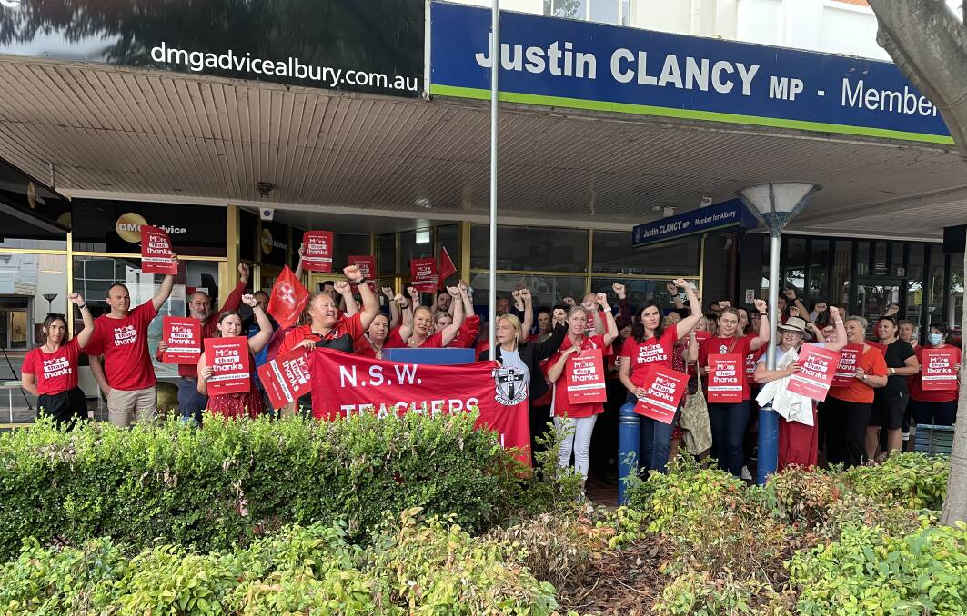 TEACHERS UNITED: Teachers stand together outside member for Albury Justin Clancy's Dean Street office on Wednesday morning. Picture: JANET HOWIE