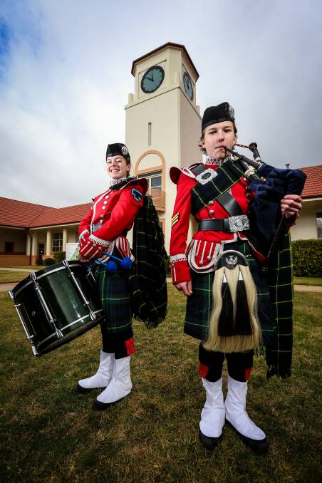BOUND FOR BRITAIN: Isabella Plunkett, 15, and George Henderson, 17, in the ceremonial dress of The Scots School Albury Pipe Band. Picture: JAMES WILTSHIRE
