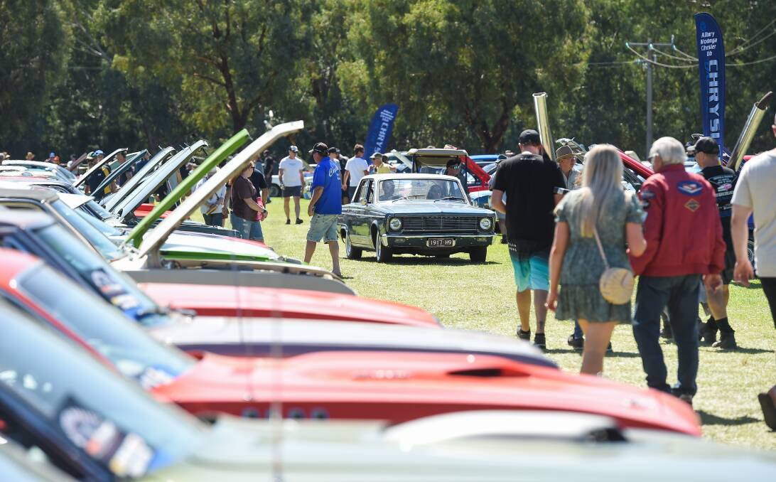 CHRYSLER CROWD: Car enthusiasts check out the entries at Gateway Lakes yesterday. The expanded show struggled for space, with Chryslers also spotted in the public parking area on the other side of Lincoln Causeway. Picture: MARK JESSER