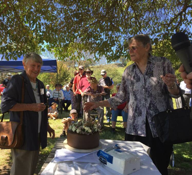 CATCHING UP: Wodonga Historical Society's Jean Whitla, who opened the Granya Pioneer Museum in 1998, and Granya resident Enid Warnock prepare to cut the cake. Mrs Warnock was a founding member of the museum.