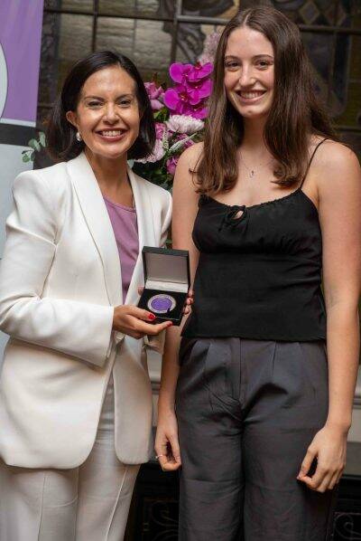 Deputy Premier and Minister for Education Prue Car presents Emma Ferguson with her medal for placing equal third in NSW for HSC society and culture. Picture supplied
