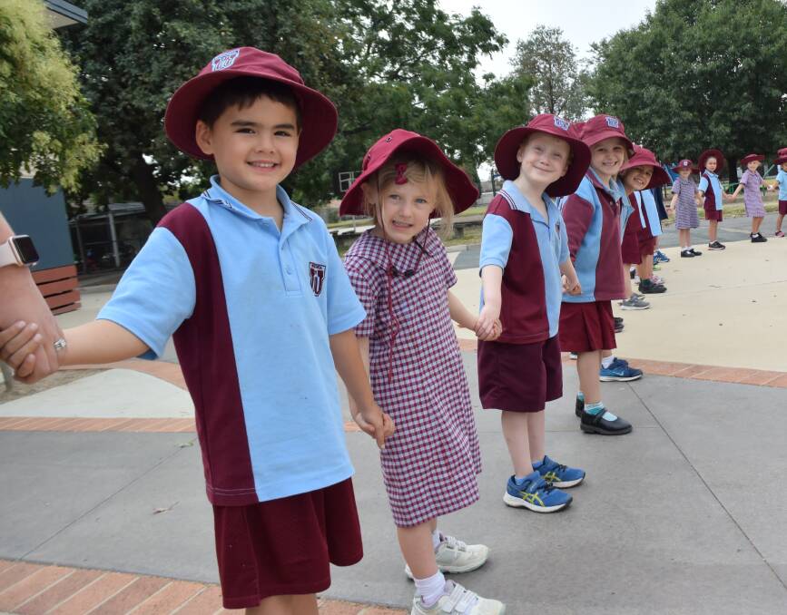 JOINING TOGETHER: Cooper Wahanui, fellow foundation classmates like Emily, Evan and Anna and about 880 other Wodonga Primary School students form the linked chain that wended its way around the school yard on Thursday.