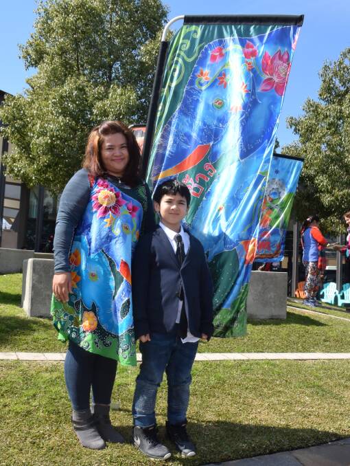 STORY FABRIC: Jinyapa Oupatham, here with her son William, 7, takes pride in the banners she designed for Lullaby and Goodnight, which opened the 2016 festival.