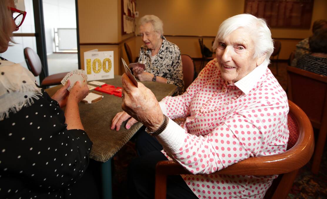 MILESTONE: "Milk and honey," Edna Bramley says when asked the secret to her long life. "I have rolled oats every morning with two tablespoons of honey on them." Her bridge club had a birthday cake ready. Picture: JAMES WILTSHIRE