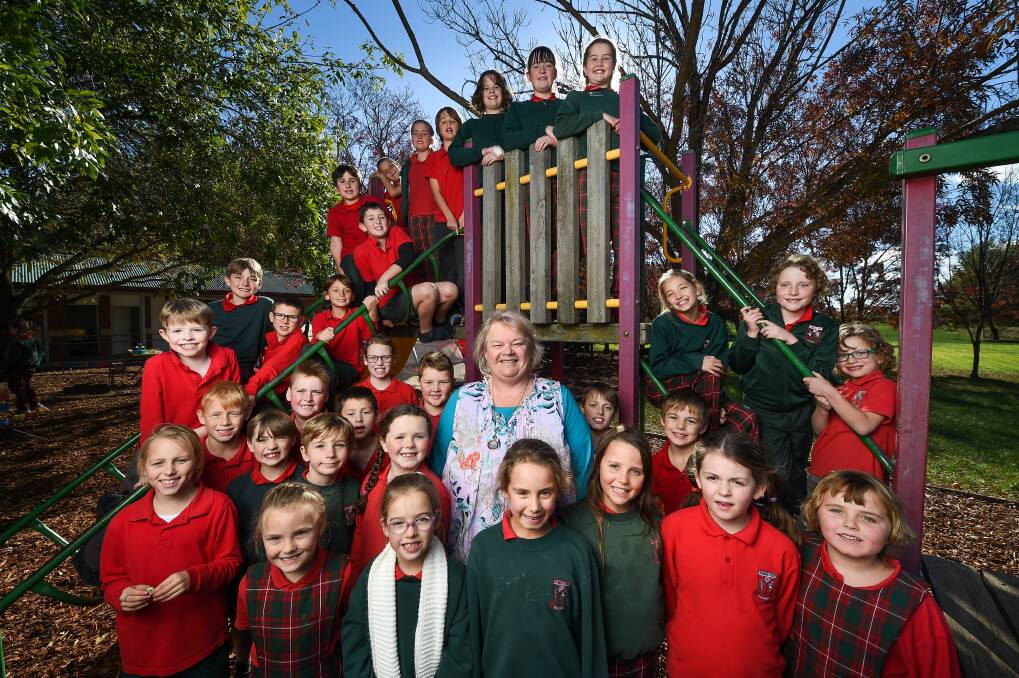 CAREER CLOSES: Elaine Kirk with the current crop of Table Top Public School students. Picture: MARK JESSER