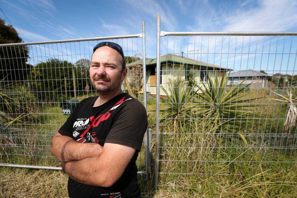North Albury resident Daniel Wilson is concerned by the safety hazard posed by the vacant house on an overgrown block at the corner of Calimo and Plover Streets. Picture by James Wiltshire