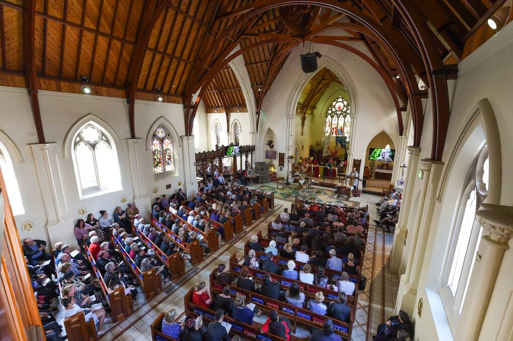 PACKED CHURCH: With every seat filled at St Matthew's Albury, some mourners stand up the back or outside. Picture: MARK JESSER