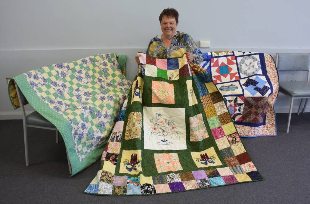 LABOUR OF LOVE: Creative Learners president Paula Smedley displays some of the 18 handmade quilts donated to Westmont Aged Care Services, Baranduda, yesterday.