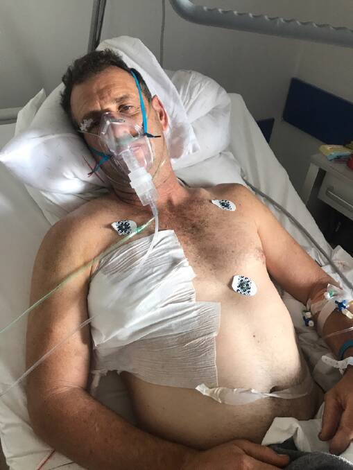 INCAPACITATED: Andrew Houlihan lies in his hospital bed in Greece. He says writing a daily blog about his experiences helped distract him during a challenging time.