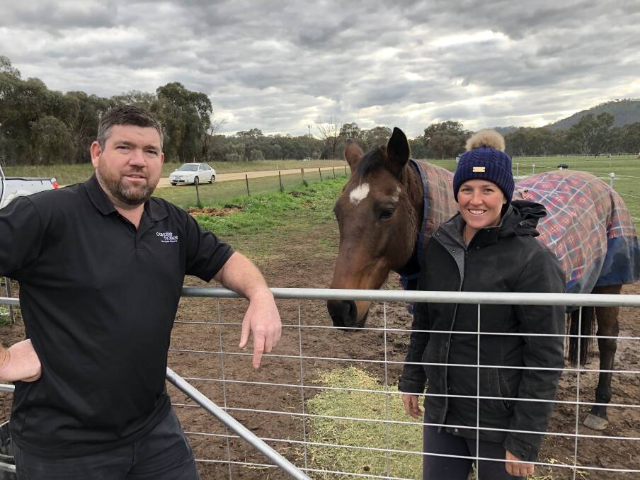 HOMEWARD BOUND: Dale Paddle, of Cavalier Homes Albury-Wodonga, and client Jade Willis, who retrains thoroughbreds, are talking house plans again after coronavirus uncertainty halted progress on Ms Willis' Barnawartha home.
