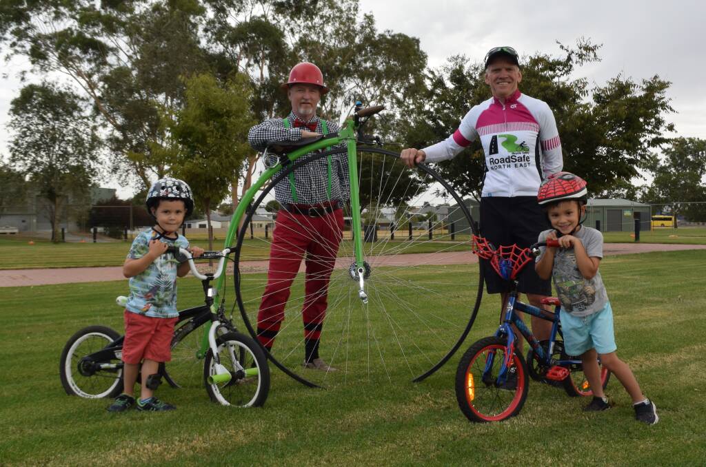 BIG WHEELS: David Hawkins' penny-farthing towers over the bikes ridden by Lewis Buckley and Lewis Klepiak, both 4, with Glenn Clarke always encouraging safety first.