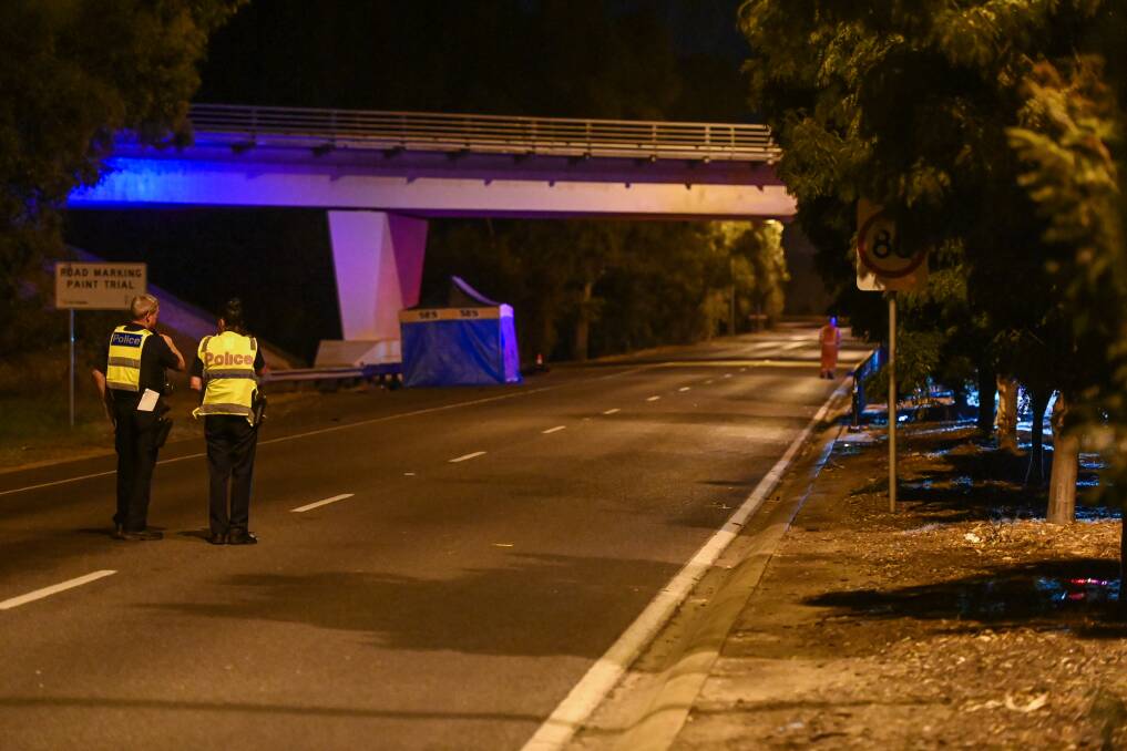 SAD SCENE: Police officers oversee the crash site on Lincoln Causeway, Wodonga. Picture: MARK JESSER