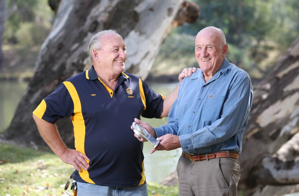 WELL DONE: Rotary Club of Albury president Mike Burke congratulates Alan Morcombe on achieving 50 years of membership with the community group. Picture: KYLIE ESLER