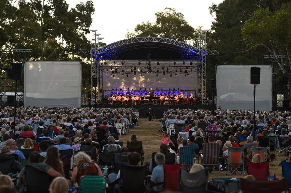 MUSICAL FEAST: As daylight fades at Beechworth golf course, a large crowd enjoys the varied program of opera, musical theatre, orchestral works and political satire. Picture: MARK JESSER