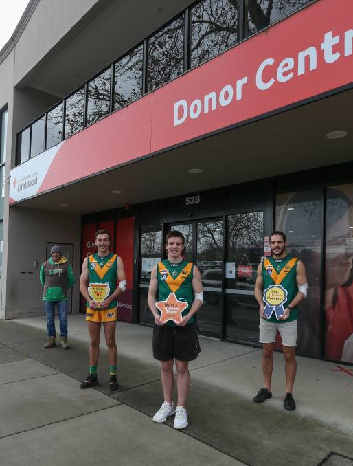 GOOD CAUSE: North Albury Football Netball Club president Tony Burns and players Will Maclean, Flynn Gardiner and Isaac Keighran take up the challenge at Albury Donor Centre on Saturday. Picture: TARA TREWHELLA