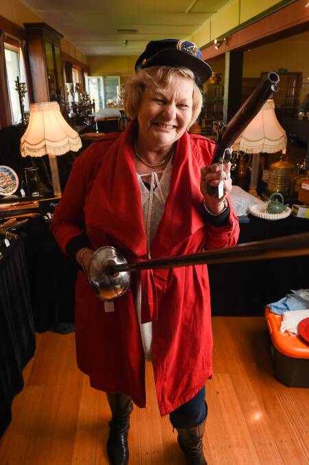 ALL THINGS MILITARY: Altona collector Carol Dennis displays some of the wares on offer at Chiltern Antique Fair. Picture: MARK JESSER